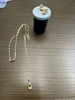 Necklace and earrings displayed on tabletop