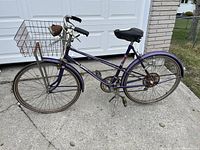 Side view of purple CCM Esprit bicycle showing overall condition, rear basket, tires, and frame.