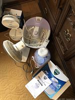 Full view of lot with fan, foot bath, humidifier with box and manual
