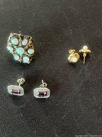 Photo showing gold plated opal ring with multiple opals and two pairs of earrings, pearl studs and garnet earrings