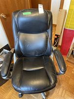 Front view of black faux leather office chair, showing overall condition and structure