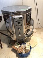 Full view of Paragon kiln showing stainless steel exterior, lid, control panel and cone basket at base