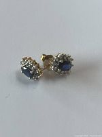 Pair of stud earrings angled on white background