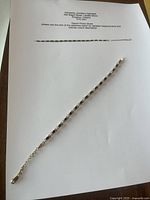 Full bracelet on paper — shows overall length, design, and clasp.