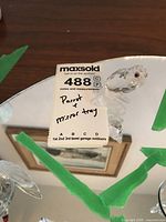 Crystal parrot figurine perched on the mirror tray, showing full setup with price tag and lot number