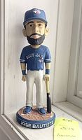 Front view of the Jose Bautista bobblehead in Blue Jays uniform holding a bat, standing on base with name.