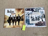 Front view of the factory sealed 2007 Beatles calendar and the Beatles promo card side by side