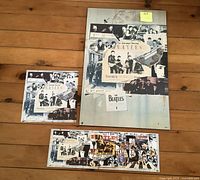 Three Beatles Anthology posters arranged on a wooden floor, showing sizes and collage designs.