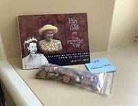 Collector card featuring 2003 Queen Elizabeth II Canadian coin set and a zip-lock bag of pennies.