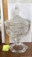 Full view of the heavy crystal candy dish with lid, showing height beside a ruler (approx. 11 inches).