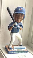 Front view of bobblehead showing Edwin Encarnacion in batting stance with bat, Toronto Blue Jays uniform and helmet, with Toronto Star logo on base.