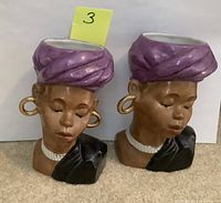 Front view showing both head vases with detailed facial features, jewelry, and purple turbans.