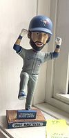 Front view of a 2015 Toronto Blue Jays Jose Bautista bobblehead in gray uniform with helmet and raised arms