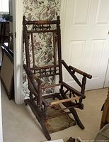 Front and side view of the antique wooden platform rocker frame stripped of upholstery and seat materials.