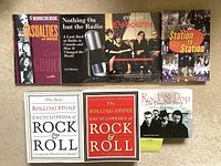 Books laid flat showing front covers of all 7 rock music books