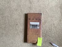 Front view of the factory sealed 3-disc CD box set Across the Great Divide by The Band with brown vintage design and photo.