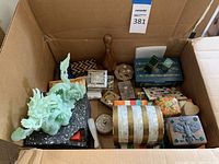 Wide view of the contents of the box containing multiple decorative items including the jade dragon statue and various boxes