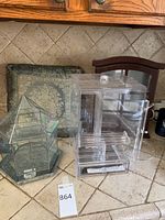 Two display boxes and a decorative pillow placed on kitchen counter.