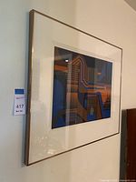 Framed abstract artwork hung on a wall with visible limited edition tag number 55/250 and group number 417.