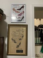 Photo of wall showing two framed ladies shoe prints stacked vertically and lady mannequin bust to the left side