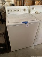 Full view of the Kenmore Elite washing machine showing white exterior and general condition