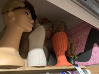 Shelf of six assorted mannequin heads and busts