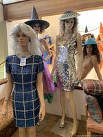 Group shot of four dressed mannequins in room