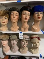 All eight mannequin heads on two shelves showing full lot