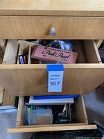 Top drawer partially open showing Pink Pearl eraser, Maxell disc pack, wooden organizer and bag of pens