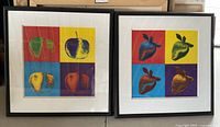 Photo of two framed silkscreen prints of fruit in vibrant colors, each print approximately 30 by 31 inches, showing apple and strawberry images in a grid of four distinct colored blocks.
