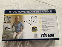 Box showing front panel with product name, image of elderly woman using the handle, features of product including support, versatility, secure strap, weight capacity, and organizer pouch included.