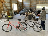 Black Diamondback and red Miele mountain bikes side by side in storage area