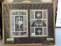 Framed double print behind glass showing two classical-themed designs, one with urn and floral decoration, the other with swans and urn, in gold frame.