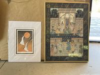 Photo of two framed pictures: one with an Oriental theme in gold frame and one art card featuring 'Sunset Sailors'