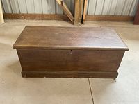 Closed wooden blanket box with flat top and keyhole in front