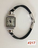 Full view of watch face, case, and strap laid flat