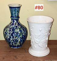 Photo showing both blue and white pottery vases side by side for size and comparison.