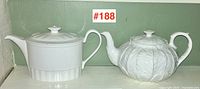Overview of two teapots side by side on shelf