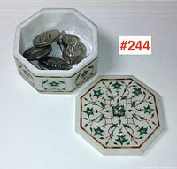 Octagonal alabaster inlaid box open to show contents of metal buttons and earrings