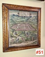 Framed historical map mounted on wall in bird's eyes maple veneer frame, showing overall condition and coloration.