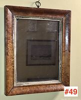 View of full antique bird's eye maple veneer frame with mirror showing entire piece and hanging ring.