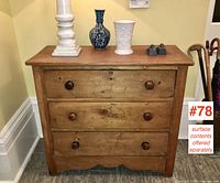 Front view of entire chest showing three drawers, round knobs, scalloped base apron
