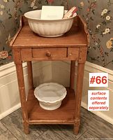Front view of pine open washstand showing drawer, lower shelf, and raised gallery back