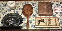 Overhead view of all five items showing the letter holder, wooden spoon, Florentine box, ceramic container, and Flemish art plaque.