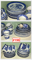 Stacks of dinner plates, saucers, cups and bowls showing overall lot composition