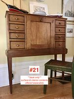 Full-frontal view of desk showing overall form, drawer layout, legs