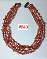 Full view of the coral 4-strand necklace, showing the entire length and clasp.