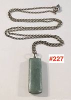 Photo of the full necklace with rectangular jade pendant showing length of chain and overall appearance.