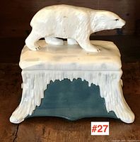 Front view of the ceramic polar bear box showing the bear on top and the icicle textured base.