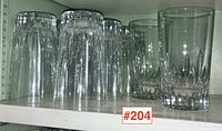 Group shot of ten glasses on shelf with ruler visible